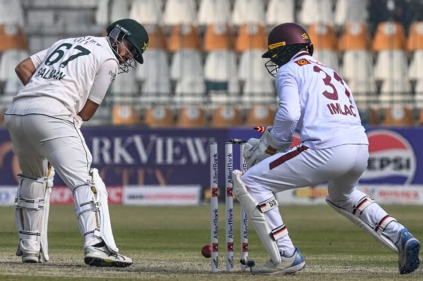 Pakistan's Salman Agha is clean-bowled by West Indies's Jomel Warrican