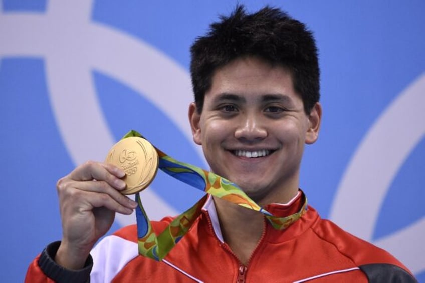 Singapore's Joseph Schooling with his gold medal after beating Michael Phelps to win the 1