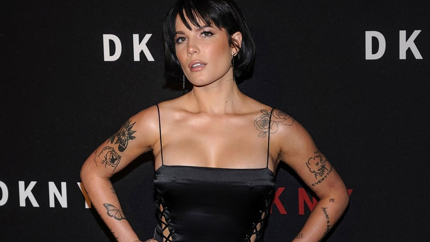 Halsey wears a black dress