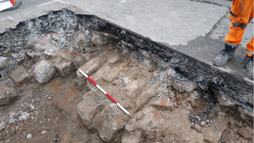 Worker standing next to bricks