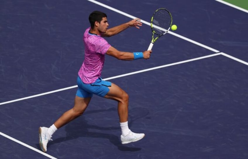 Spain's Carlos Alcaraz plays a backhand on the way to a third-round victory over Felix Aug