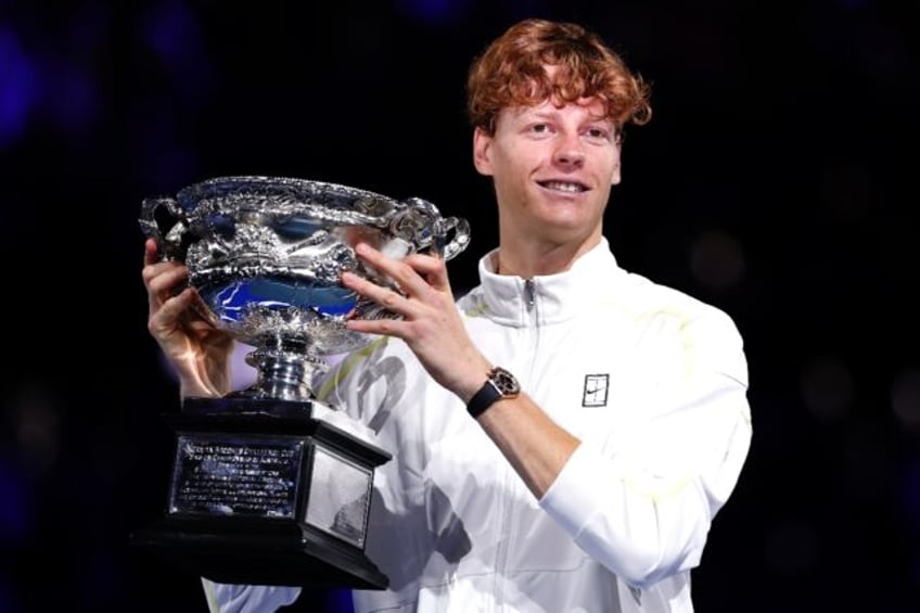 Italy's Jannik Sinner celebrates with the Australian Open trophy