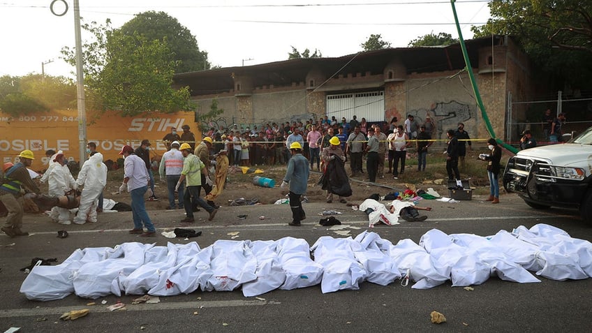 Bodies are placed on the side of the road after an accident in Tuxtla Gutierrez, Mexico, Dec. 9, 2021.