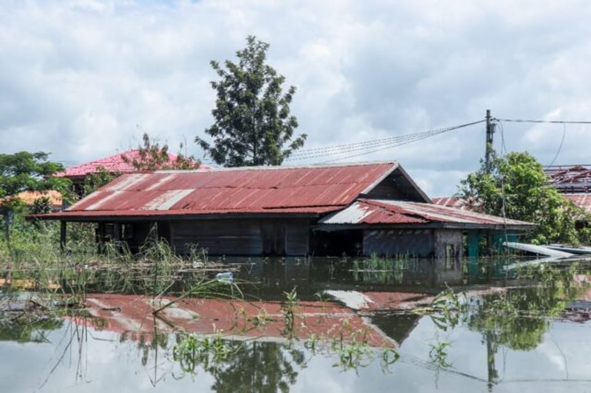 Almost 400,000 people have been forced from their homes by floods in Myanmar, piling miser