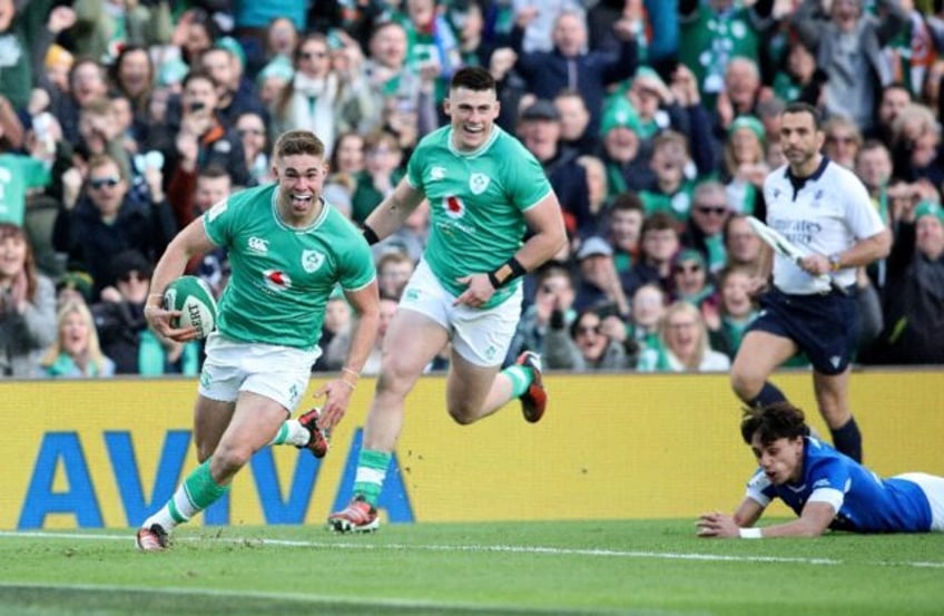 Breaking his duck: Ireland fly-half Jack Crowley (L) runs in to score his maiden senior tr