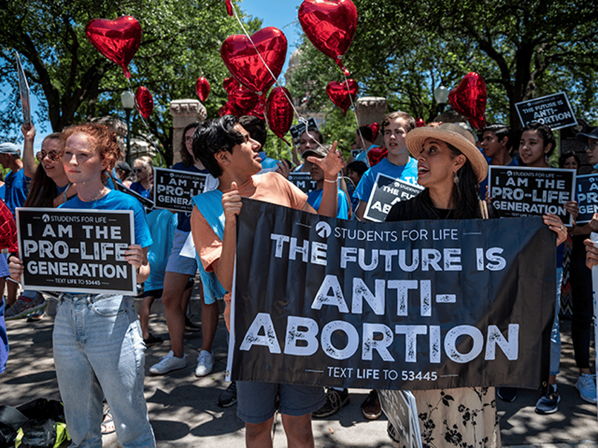 Pro-life protesters stand near the gate of the Texas state capitol at a protest outside the Texas state capitol on May 29, 2021 in Austin, Texas. Thousands of protesters came out in response to a new bill outlawing abortions after a fetal heartbeat is detected signed on Wednesday by Texas …