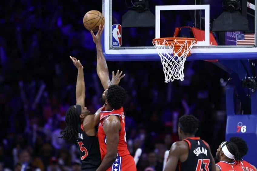 Philadelphia's Joel Embiid blocks a shot by Toronto's Precious Achiuwa in the 76ers' NBA victory over the Raptors