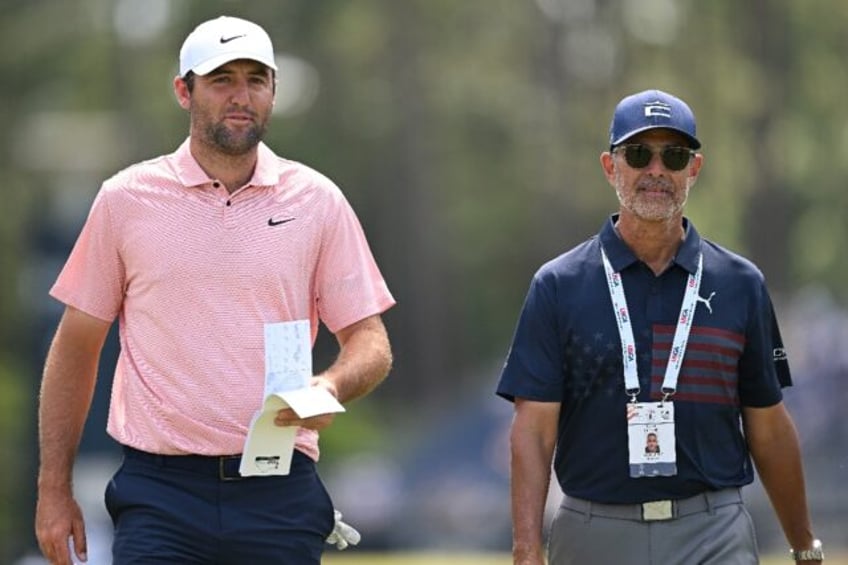 World number one Scottie Scheffler, left, walks with golf instructor Claude Harmon III on