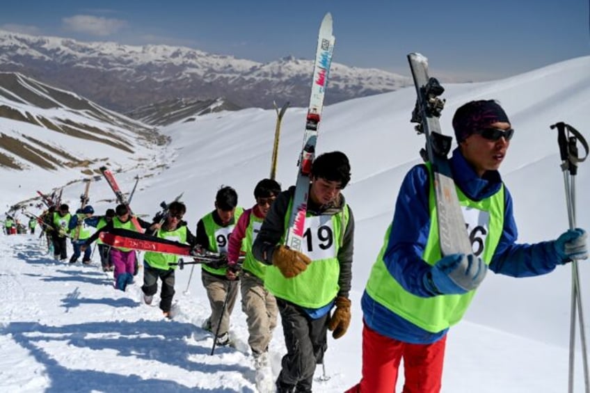 Wearing a hodge-podge of warm clothes and neon pinnies, a long line of competitors shoulde