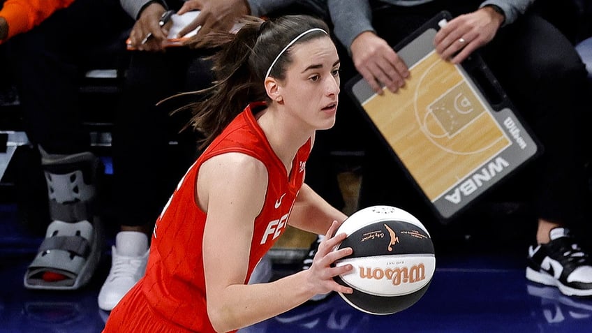 Caitlin Clark dribbles the ball