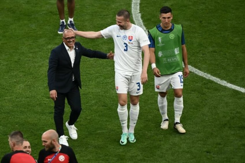 Slovakia coach Francesco Calzona (L) celebrates his side's win against Belgium