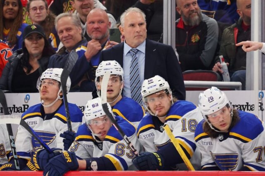 Craig Berube, standing behind players on the bench, was fired as head coach of the NHL's St. Louis Blues