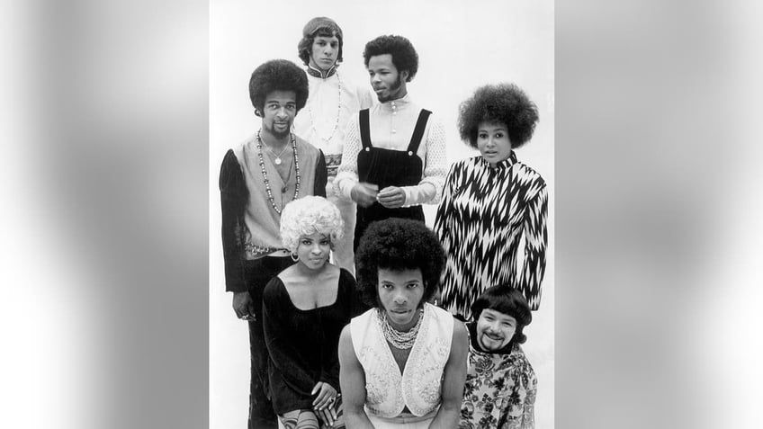 A group shot of Sly Stone and the Family Stone posing together.