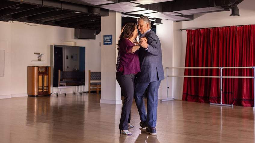 Business owners dance in their studio