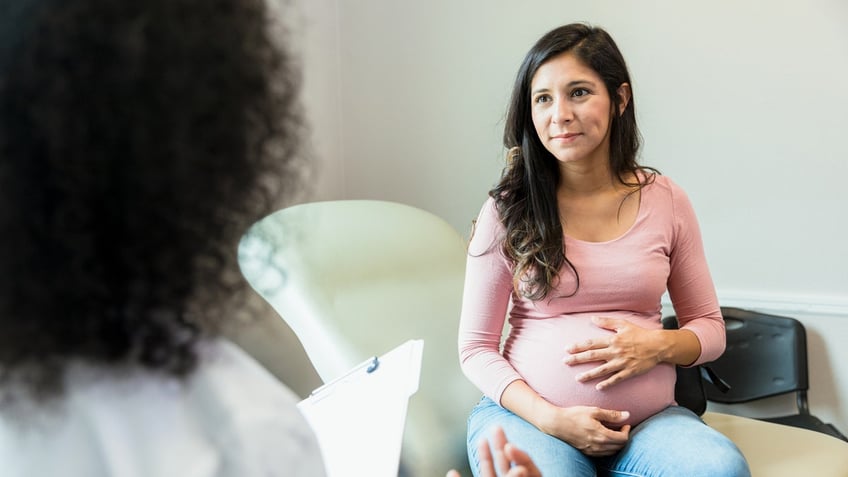 Pregnant woman with doctor