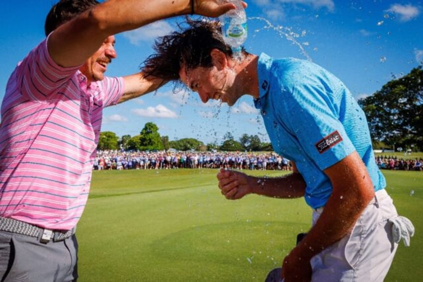 Australia's Elvis Smylie (R) celebrates after winning the Australian PGA Championship in B