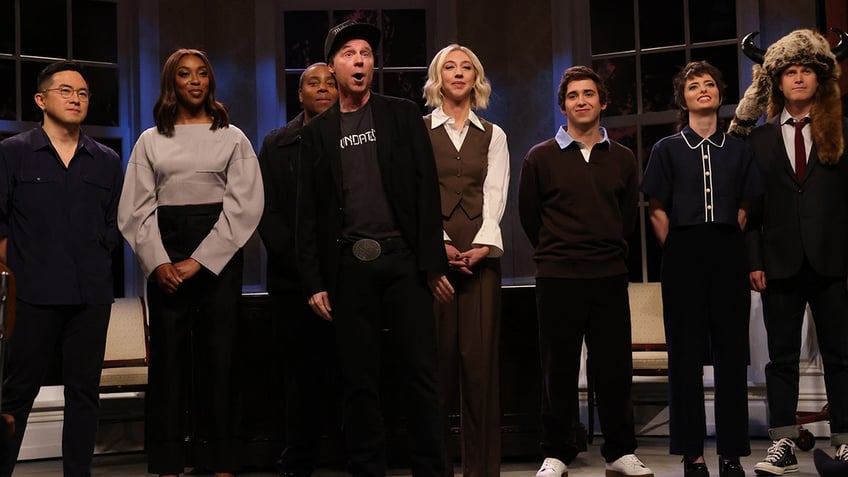 Bowen Yang, Ego Nwodim, Kenan Thompson, Dana Carvey playing Elon Musk, Heidi Gardner, Marcello Hernández, Sarah Sherman and Colin Jost stand on stage during 'SNL' cold open