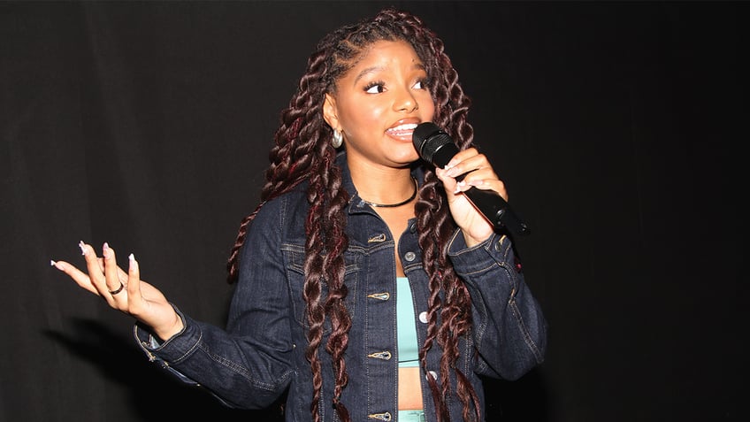 Halle Bailey using microphone