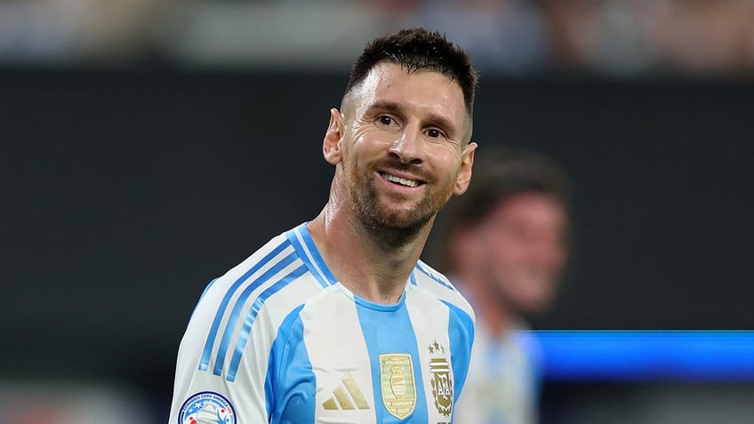 Lionel Messi smiles on field