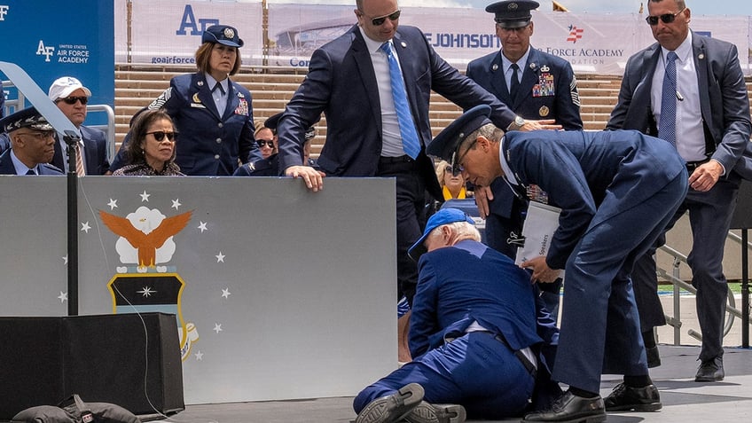 President Joe Biden falls on stage during the 2023 United States Air Force Academy Graduation Ceremony at Falcon Stadium, Thursday, June 1, 2023, at the United States Air Force Academy in Colorado Springs, Colo. (AP Photo/Andrew Harnik)