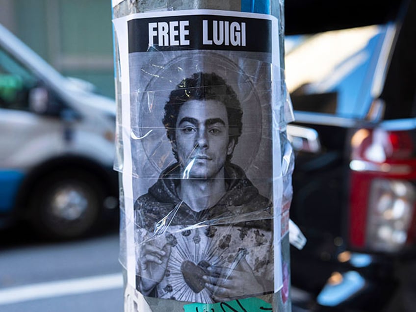 A poster depicting Luigi Mangione hangs outside the New York Hilton Midtown hotel, Thursday, Dec. 12, 2024, in New York. (AP Photo/Julia Demaree Nikhinson)