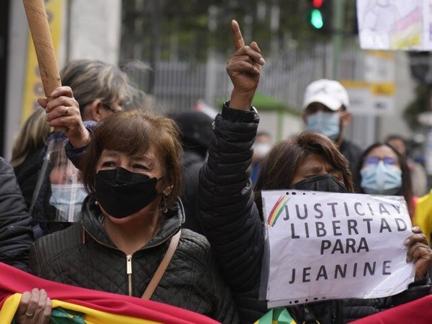 Supporters of Bolivia's former interim President Jeanine Anez gather outside the Court of Justice on Anez's first trial day, in La Paz, Bolivia, Thursday, Feb. 10, 2022. Anez is being tried for breach of presidential duties and making resolutions contrary to the Constitution. (Juan Karita/AP)