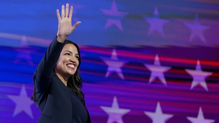 Alexandria Ocasio-Cortez (D-NY) gestures before speaking at the Democratic National Convention