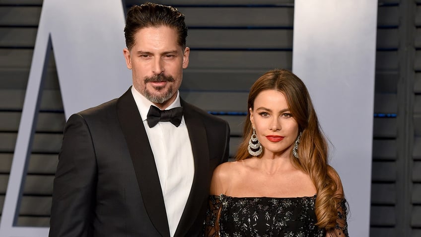 Sofia Vergara in a black sleeveless lace dress on the carpet with husband Joe Manganiello in a classic tuxedo