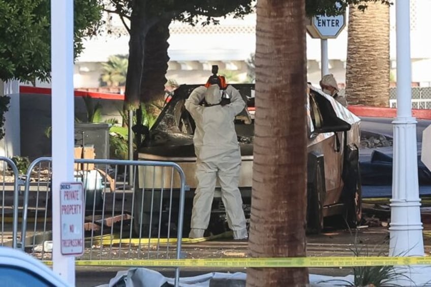 An investigator photographs a Tesla Cybertruck that exploded outside the lobby of Presiden