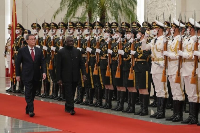 Solomon Islands has veered into China's orbit under Prime Minister Manasseh Sogavare (R)