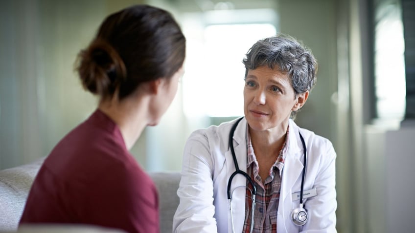 Female doctor with female patient