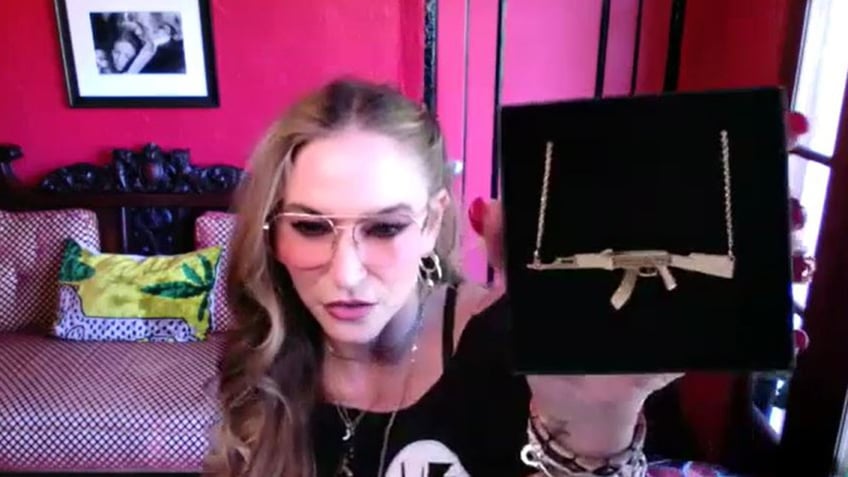 Drea de Matteo showing gun pendant