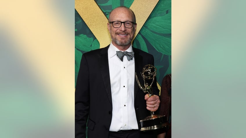 Mark Kamine holding an Emmy