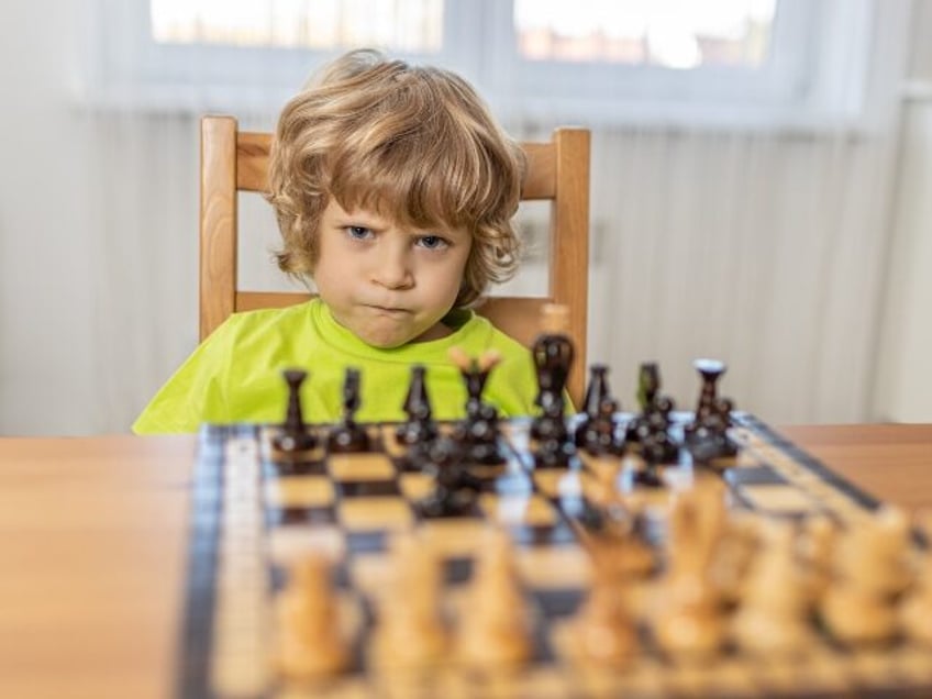 angry kid playing chess