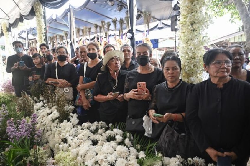 Mourners gather in central Thailand for the last rites for 20 schoolchildren and their thr