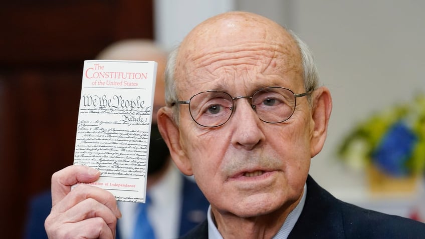 Supreme Court Associate Justice Stephen Breyer holds US Constitution