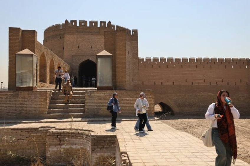 Iraqi students walk through Bab al-Wastani on a walking tour of the historic centre of Bag