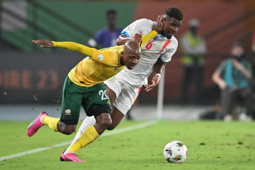 South Africa defender Khuliso Mudau (L) fights for the ball with DR Congo midfielder Aaron