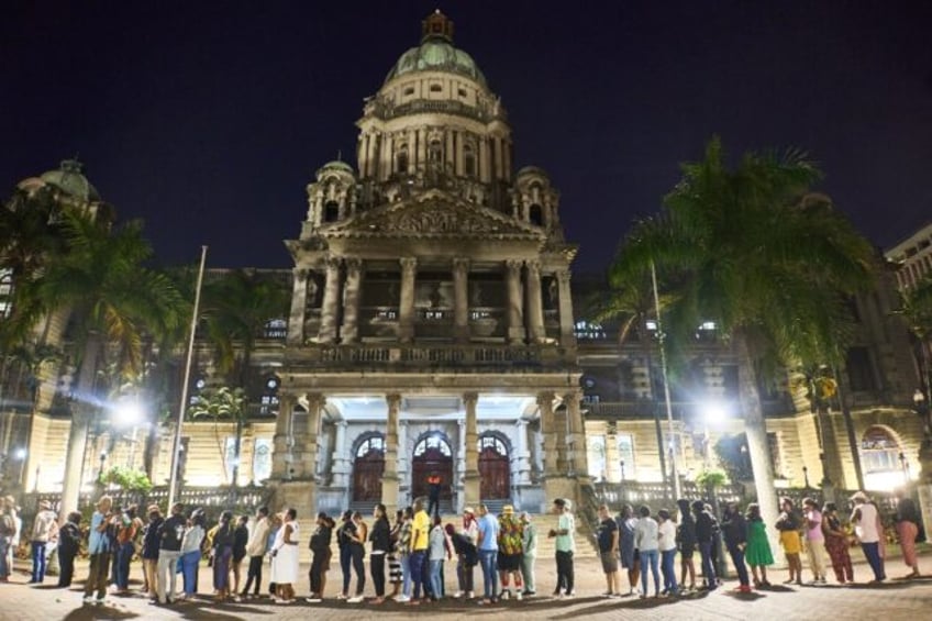 Voters queued long into the night after stations were overwhelmed by the high turnout