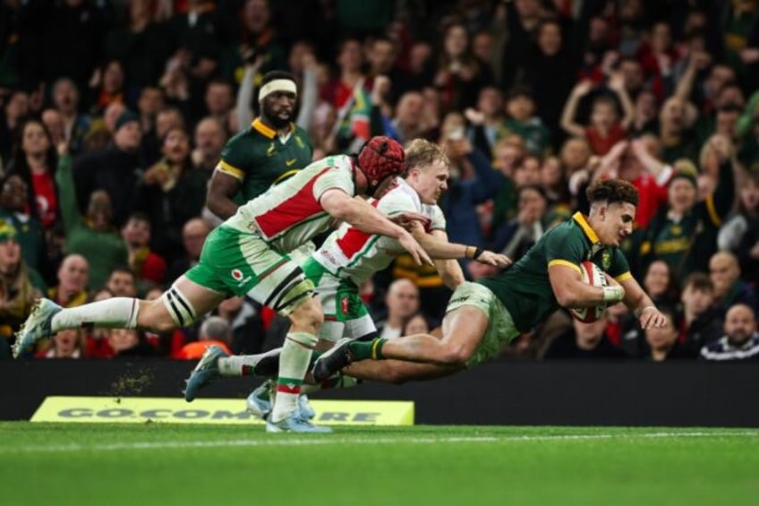 Over and out: Jordan Hendrikse scores South Africa's final try in Saturday's rout of Wales