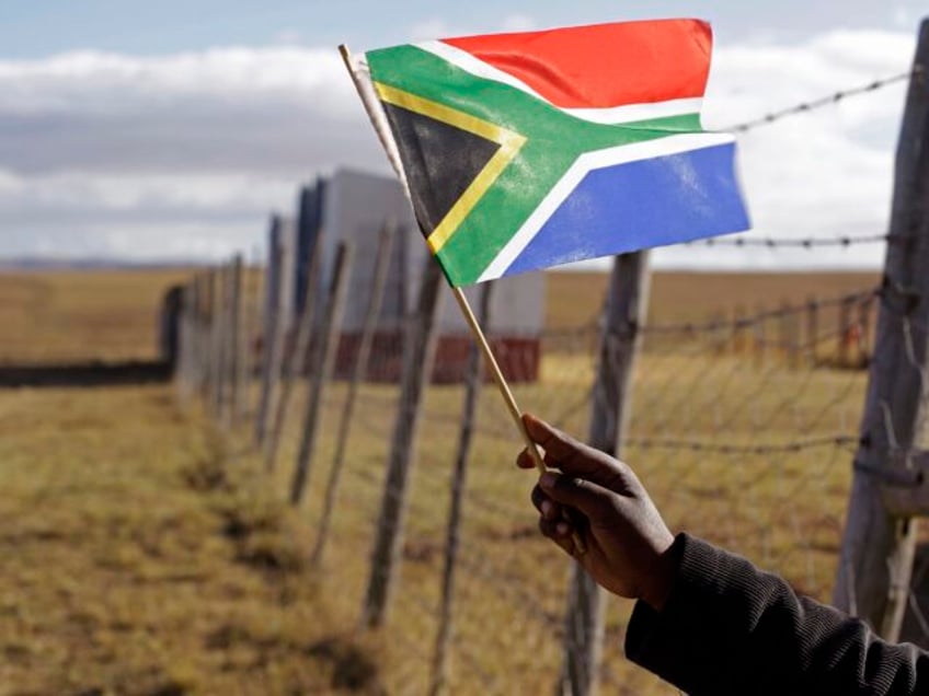 A child holds a flag at the No-Moscow school during celebrations for former South African