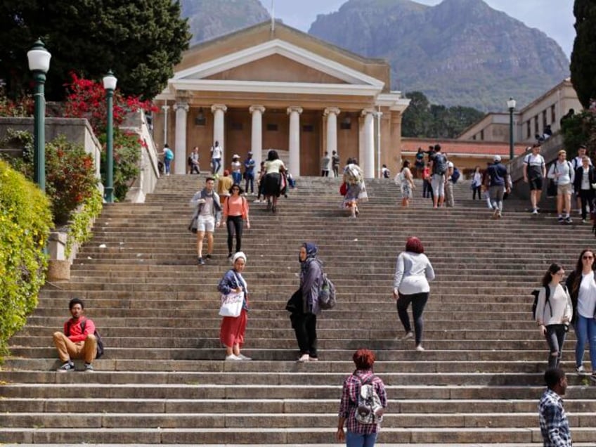 Students at the University of Cape Town campus interact as they return to class during cou