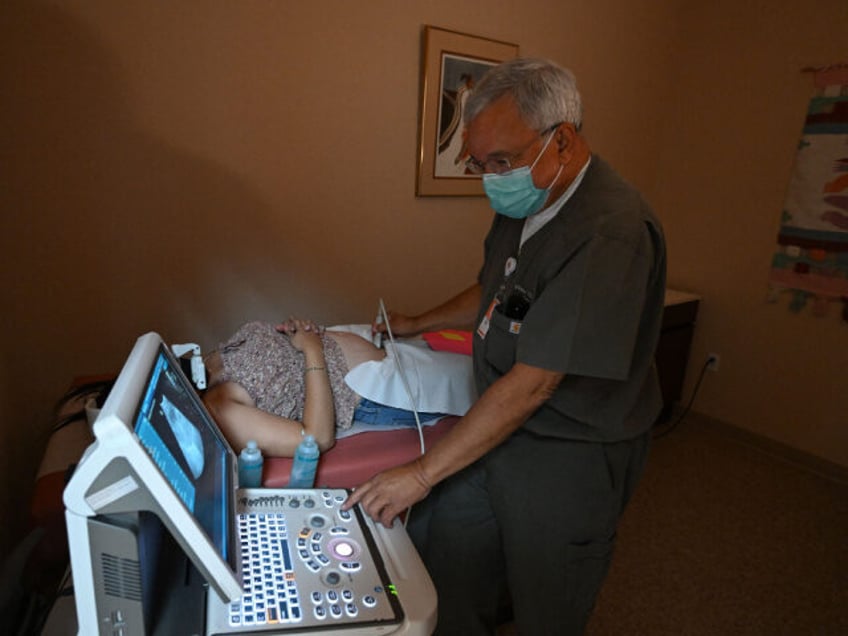 Dr Franz Theard performs a sonogram to confirm pregnancy on a patient seeking abortion ser