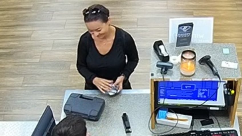 Mica Miller at a pawn shop where she purchased a 9 mm Sig Sauer