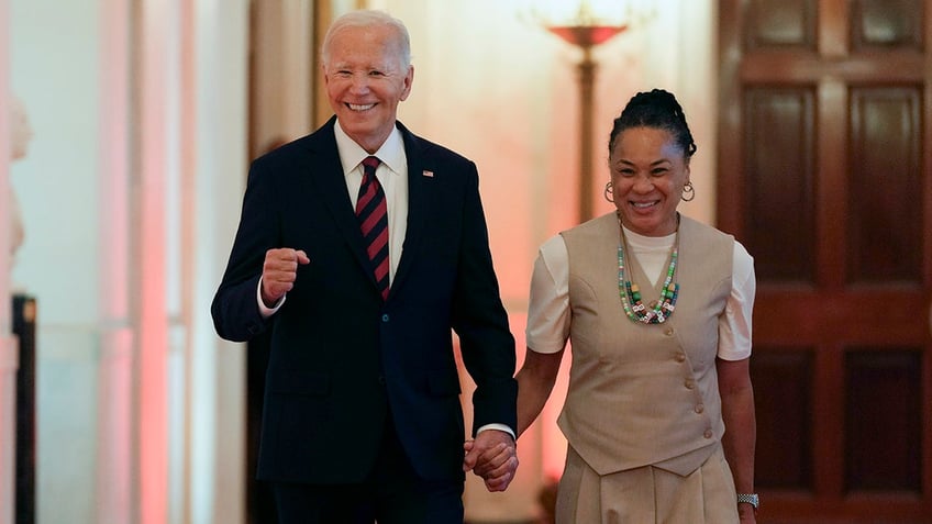 Dawn Staley holds Joe Biden's hand