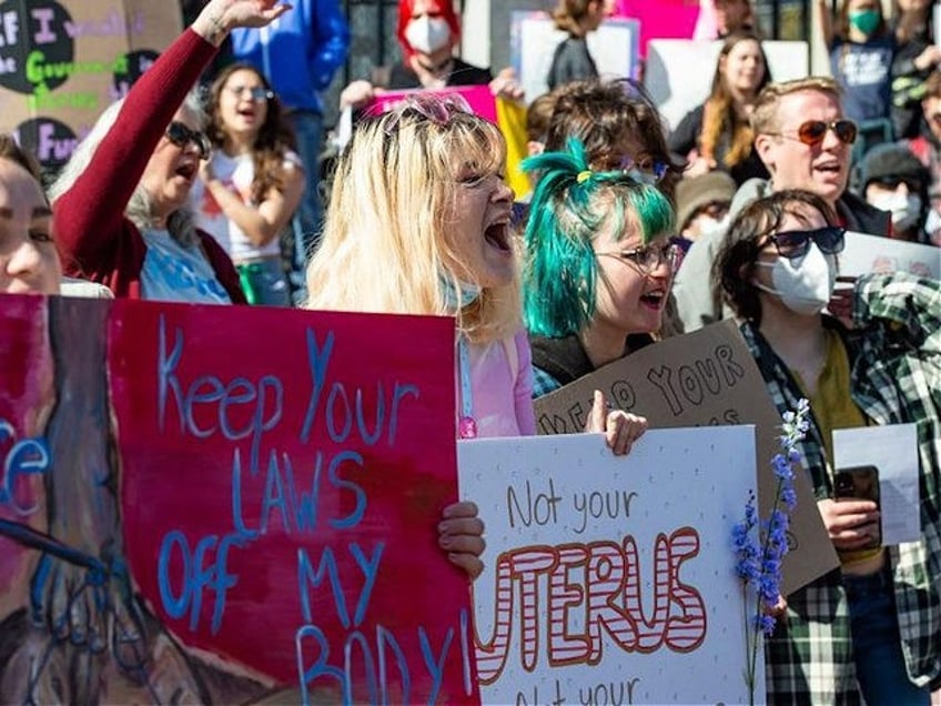 Pro-choice demonstrators rally outside the State House during a Pro-Choice Mother's Day Ra