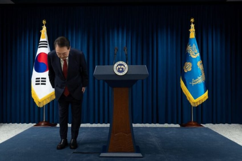 South Korean President Yoon Suk Yeol bows after apologising for his declaration of martial