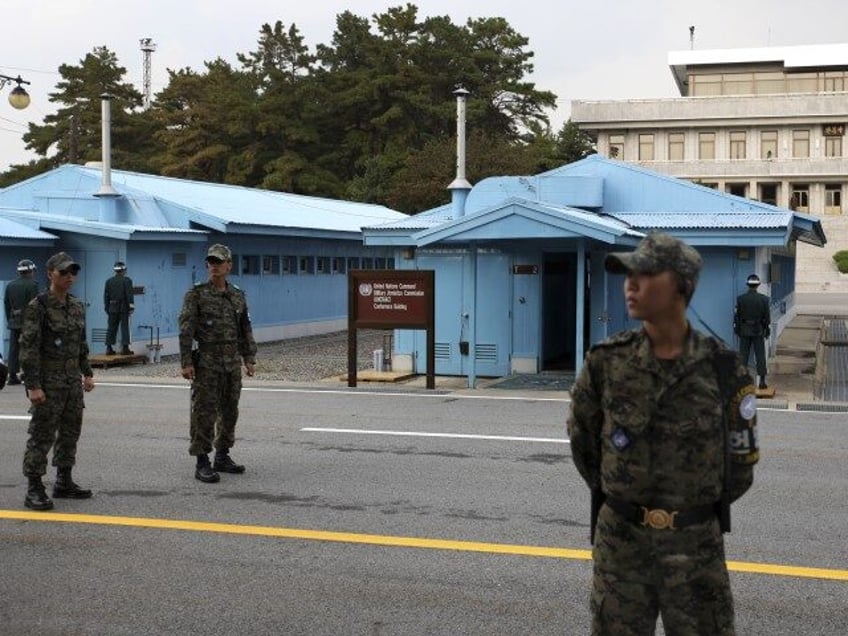 South Korean soldiers stand guard at the border village of Panmunjom that separates the tw