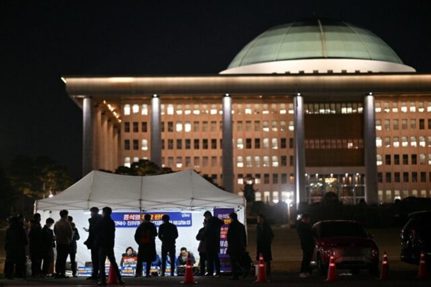 Demonstrators take part in a sit-in protest calling for the ouster of South Korea Presiden