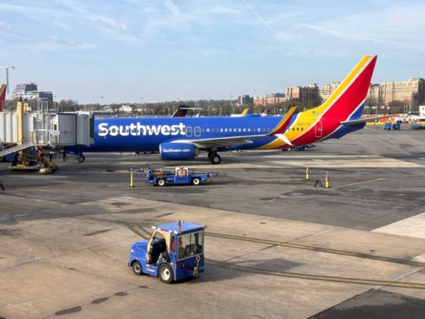 A Southwest Airlines Boeing 737 sits at a gate at Washington's Reagan National Airport (DC